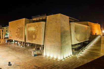 For two consecutive years, Malta’s Parliamentary Health Committee, one of the most significant bodies entrusted with overseeing public health policies and institutions, remained inactive. During this period, the committee was chaired by Parliamentary Secretary Malcolm Agius Galea, who admitted that he did not convene any meetings. His justification was rooted in what he described as an “apparent conflict of interest,” since he simultaneously held a ministerial role within the Health Ministry. The prolonged inactivity of the committee attracted criticism from observers and stakeholders who argued that important discussions on healthcare reforms, regulatory oversight, and pressing issues such as mental health and hospital management were being ignored. Despite Galea raising the issue with the Prime Minister, the Labour parliamentary group took two years before appointing a new chairperson to replace him. This long delay has had consequences for parliamentary scrutiny. In a healthcare sector increasingly marked by regulatory challenges and demands for better accountability, the absence of consistent parliamentary oversight has been seen by experts as a democratic shortcoming. Romilda Zarb appointed chairperson In 2023, Labour MP Romilda Zarb, a former Mosta mayor, was appointed chairperson of the Health Committee. Her appointment was expected to revitalise the parliamentary body and restore oversight after years of stagnation. However, Zarb’s new role has quickly become controversial. Unlike her predecessor, her professional career within the very sector she is tasked with scrutinising has raised concerns over whether she can objectively lead the committee. Employment ties to the Health Ministry Shortly before entering Parliament as a backbencher in 2022, Zarb was employed at the Malta Medicines Authority (MMA), one of the country’s main regulatory bodies in the health sector. She was recruited as a Senior Regulatory Pharmacist, a position reportedly granted under the chairmanship of Professor Anthony Serrachino Inglott, who continues to lead the Authority at the age of 80. In this role, Zarb has direct responsibilities, including overseeing medical devices used in both government hospitals and the broader healthcare industry. Her professional duties require her to ensure compliance and enforce standards in the very institutions that fall under the Health Committee’s remit. This overlap between her parliamentary function and her employment within the health regulatory framework has drawn scrutiny. As chairperson of the committee, Zarb receives an additional €10,000 annually in parliamentary honoraria, supplementing her existing public employment income. The question arises: how can an MP effectively hold accountable the same institutions from which she draws her livelihood? Apparent conflict of interest When asked by journalists from The Shift to comment on what appears to be a conflict of interest, Zarb reportedly struggled to provide a direct response. Instead, she requested that questions be sent in writing. According to reports, no reply was received despite follow-up reminders. This silence has done little to quell public doubts. Conflict of interest is not solely a legal question but also an ethical and political one. For many, Zarb’s dual role raises fundamental questions about transparency, impartiality, and whether parliamentary committees are being allowed to function with the independence they are meant to embody. Other MPs in similar positions Zarb is not the only committee member who is also employed within the public health sector. Opposition MP Ian Vassallo, a member of the Nationalist Party, works as a podiatrist both in government service and in the private sector. However, unlike Zarb, Vassallo is not chairing the committee nor responsible for setting its agenda. While potential conflicts could arise in specific discussions or votes, his situation has not attracted the same level of concern. The crucial difference lies in Zarb’s role as committee chair, which gives her the power to shape the committee’s priorities and determine which issues are placed on the agenda. The first meeting after years of inactivity After two years of suspension, the Health Committee finally convened its first meeting under Zarb’s leadership. In her introductory remarks, she highlighted mental health as one of the key areas she wishes to address during her tenure. While her stated priorities are aligned with growing public concerns about mental health services and resources, the session did not address the central question of her apparent conflict of interest. None of the MPs sitting on the committee raised objections or pressed for clarifications on whether her employment compromises the independence of her chairmanship. Malcolm Agius Galea’s approach to conflict Zarb’s situation contrasts with that of her predecessor. Malcolm Agius Galea, once he became a parliamentary secretary within the Health Ministry, refrained from convening the committee, citing the potential conflict between his ministerial responsibilities and the parliamentary role. His decision, though leading to a two-year standstill, was at least based on recognition of an ethical boundary. As a parliamentary secretary, Galea did not receive the additional €10,000 allowance linked to committee chairmanship, since members of the executive are not entitled to such remuneration. The absence of meetings during his tenure highlighted systemic weaknesses in how parliamentary oversight structures are staffed and managed. Business background of Romilda Zarb Beyond her political and regulatory roles, Zarb also has ties to the private sector. Until 2023, she served as a director on the board of Emy’s Enterprises Ltd, a family-owned company specialising in the supply of healthy food products. She resigned from her position that year and was replaced by her father, Emmanuel Zarb. Though she no longer holds a directorship, her past involvement in the company further illustrates the complexity of balancing business interests with public and parliamentary responsibilities. Broader implications for parliamentary accountability The controversy surrounding the Health Committee’s leadership is emblematic of broader concerns regarding governance in Malta. The independence of parliamentary committees is central to ensuring democratic accountability. When those tasked with scrutinising government policy are themselves employees of government entities, questions about impartiality naturally arise. Legal experts note that conflict of interest does not necessarily imply wrongdoing. However, it does raise doubts about the ability of public officials to make decisions without bias, particularly when financial or professional ties are at stake. For citizens, the perception of impartiality is as important as the reality, since trust in democratic institutions relies heavily on appearances of fairness. In the case of the Health Committee, the combination of a two-year lapse in meetings, followed by the appointment of a chairperson employed by the very ministry under scrutiny, risks undermining public confidence. Critics argue that such arrangements weaken parliamentary independence, leaving health policy oversight largely in the hands of the executive. Looking ahead As Malta faces ongoing challenges in healthcare—from ensuring the availability of medicines to addressing pressures on hospital services—the need for robust and independent parliamentary scrutiny is greater than ever. Whether Romilda Zarb can maintain the necessary distance between her parliamentary duties and her professional obligations remains an open question. The effectiveness of the Health Committee will depend not only on the issues it chooses to prioritise, such as mental health, but also on whether it can function without the shadow of conflict of interest diminishing its credibility. Conclusion The case of the Parliamentary Health Committee highlights an ongoing challenge in Malta’s political and institutional framework: ensuring that oversight mechanisms remain independent, credible, and effective. After two years of dormancy, the committee’s reactivation was expected to strengthen accountability in the healthcare sector. Instead, the appointment of a chairperson whose professional employment lies within the same sector under review has reignited concerns over impartiality and conflict of interest. While no illegality has been alleged, the perception of bias can be just as damaging as actual misconduct. Citizens expect that parliamentary committees will provide a forum for robust, independent debate on healthcare challenges, ranging from regulatory oversight to the urgent need for mental health reform. When those tasked with leading such debates are themselves closely tied to the institutions under scrutiny, the committee’s ability to inspire public trust comes into question. For the health sector—where policy decisions directly affect the well-being of the population—the importance of transparent, accountable, and impartial parliamentary oversight cannot be overstated. Going forward, the credibility of the committee will depend on whether it can demonstrate that its work is conducted without undue influence, and that public interest remains at the heart of its mandate. FAQs What is the role of the Parliamentary Health Committee? The committee is responsible for overseeing and scrutinising Malta’s health policies, institutions, and regulatory frameworks. Why was the committee inactive for two years? It was left dormant because the former chair, Malcolm Agius Galea, believed his ministerial post created a conflict of interest. Who is Romilda Zarb? Romilda Zarb is a Labour MP, former Mosta mayor, and Senior Regulatory Pharmacist at the Malta Medicines Authority. Why is there concern about Romilda Zarb’s position? She is employed by a health regulator while simultaneously chairing the committee tasked with overseeing the sector, raising conflict of interest concerns. What are Zarb’s stated priorities as chairperson? She has indicated that mental health and broader healthcare issues will be central to the committee’s work. Is Romilda Zarb still involved in private business? She resigned from her directorship in Emy’s Enterprises Ltd in 2023, with her father replacing her on the board. Does Ian Vassallo also face a conflict of interest? As a government-employed podiatrist, some conflicts may arise, but he does not set the committee’s agenda, unlike Zarb. How much does the committee chairperson earn? The chair receives an additional annual honorarium of €10,000, on top of their MP salary. What did Malcolm Agius Galea do differently? He avoided convening meetings, citing conflict concerns, though this left the committee inactive for two years. What are the broader implications of this controversy? The situation highlights concerns about impartiality, governance, and public trust in parliamentary oversight in Malta.